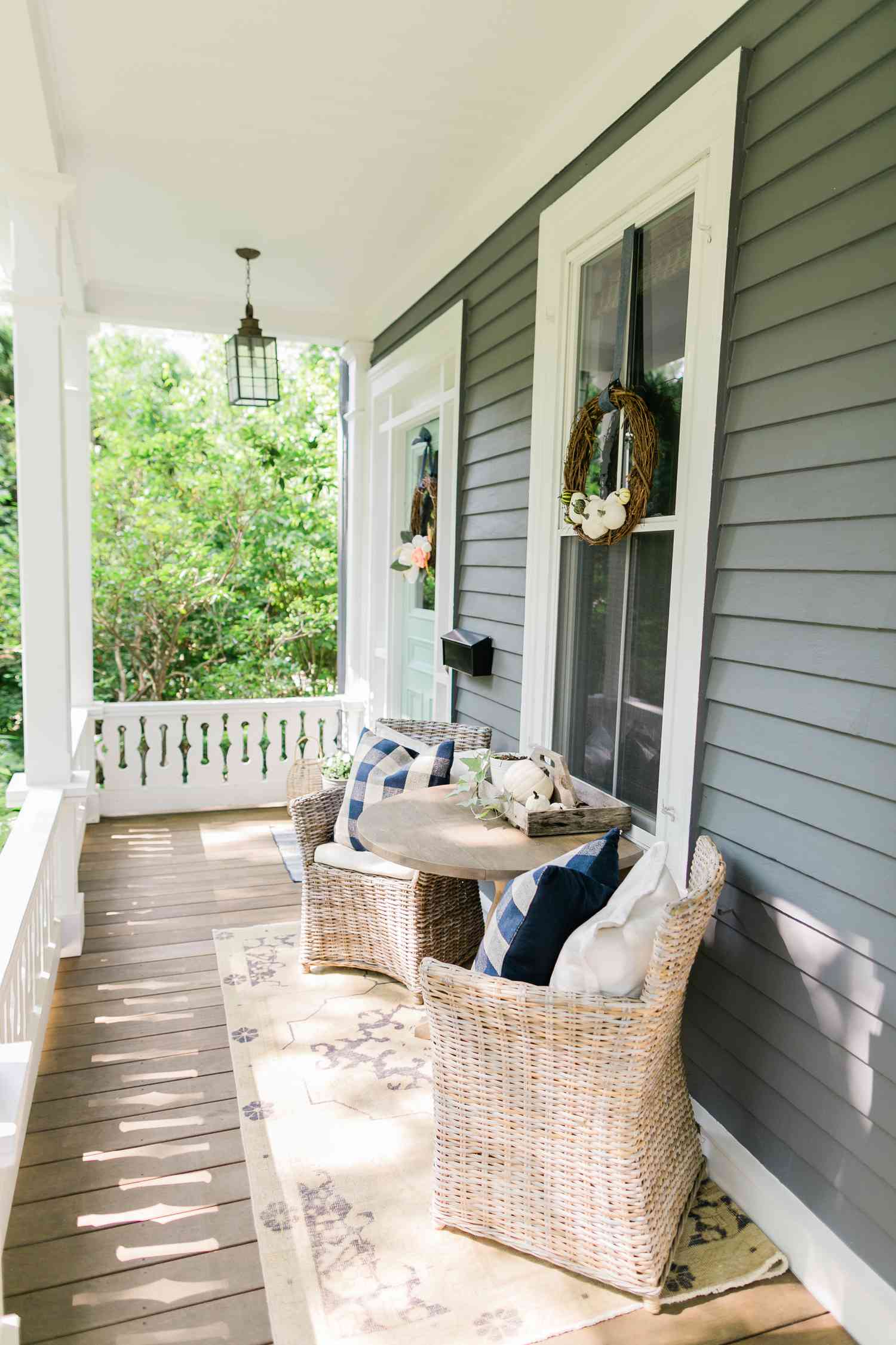 Chaises en rotin et table en bois sur le porche d'entrée