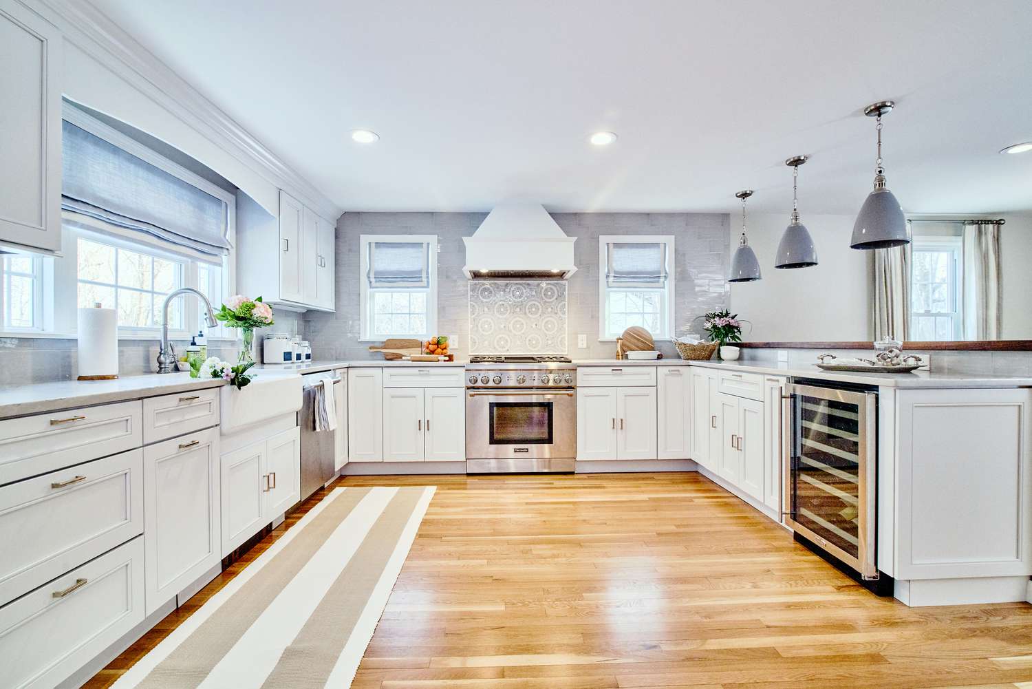 brightly lit kitchen with neutral colored cabinets