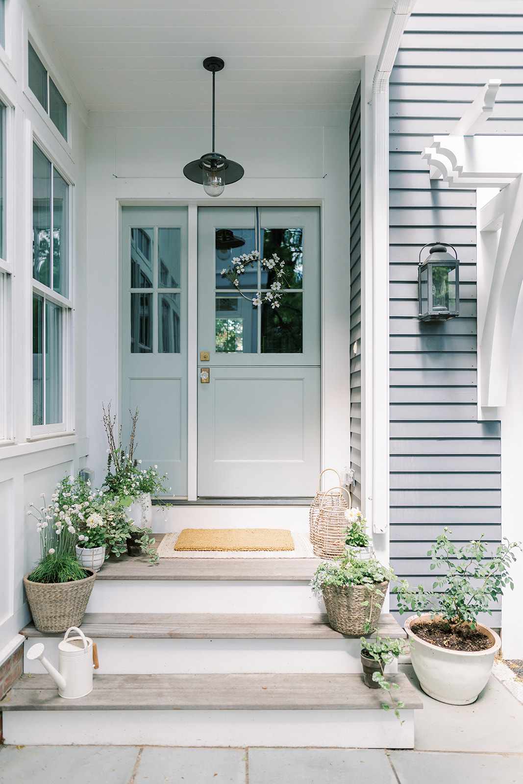 White potted plants on porch steps