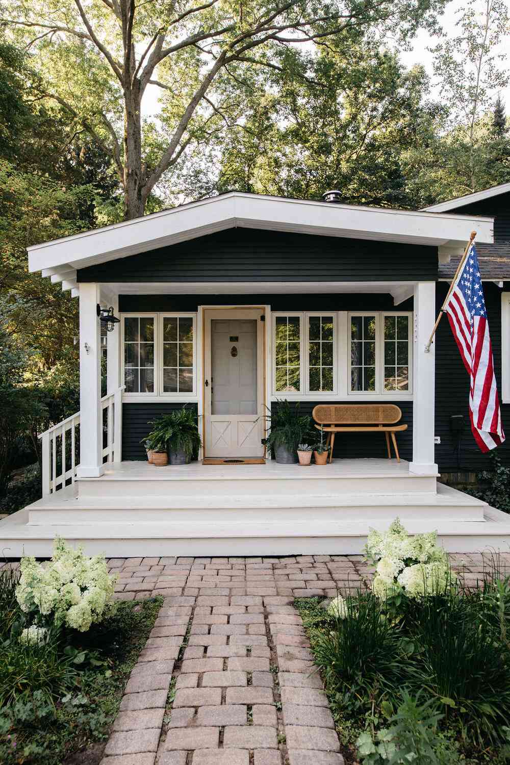 Front porch with flag hanging from column