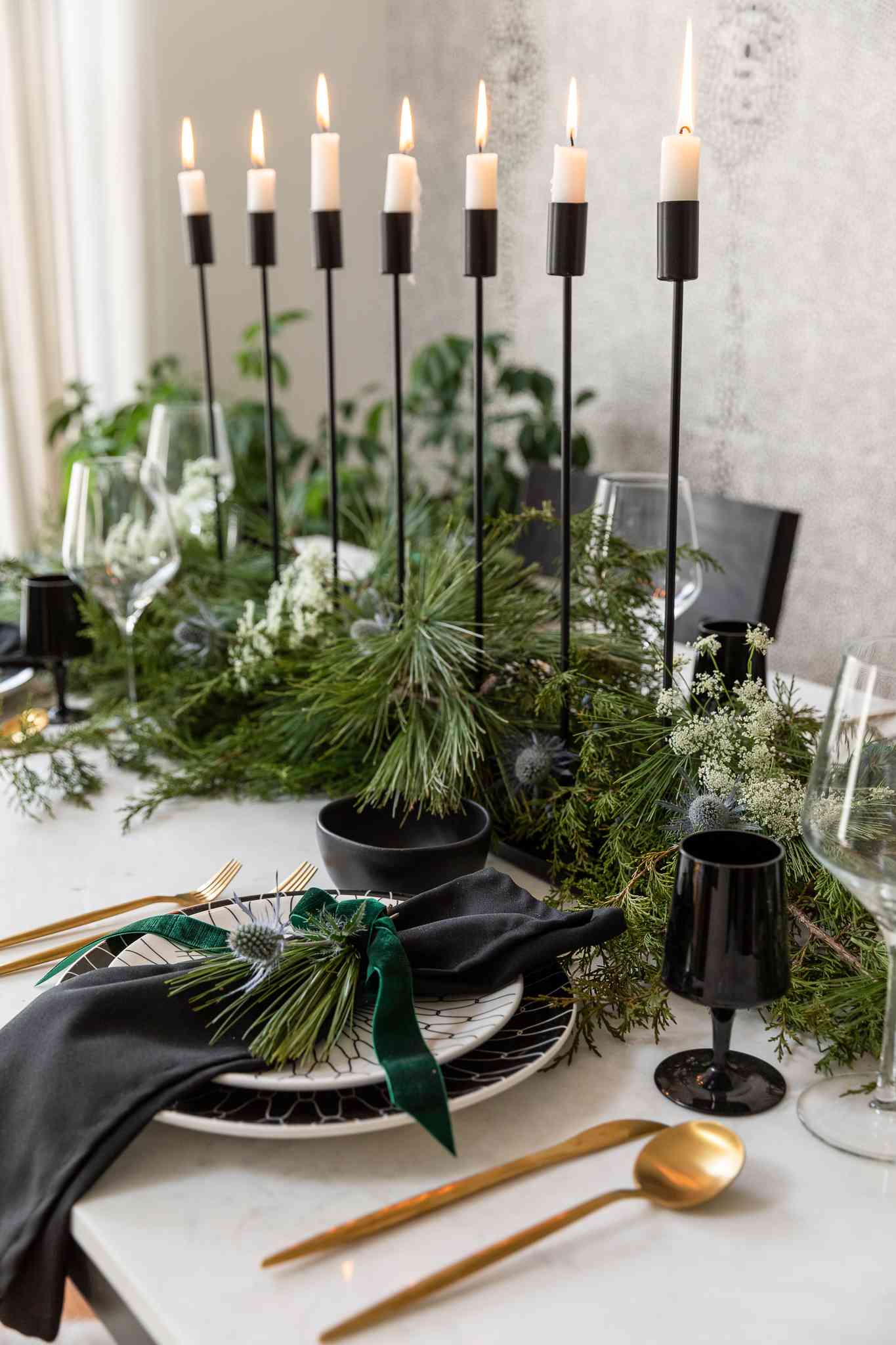 Tall black candles in Christmas tablescape