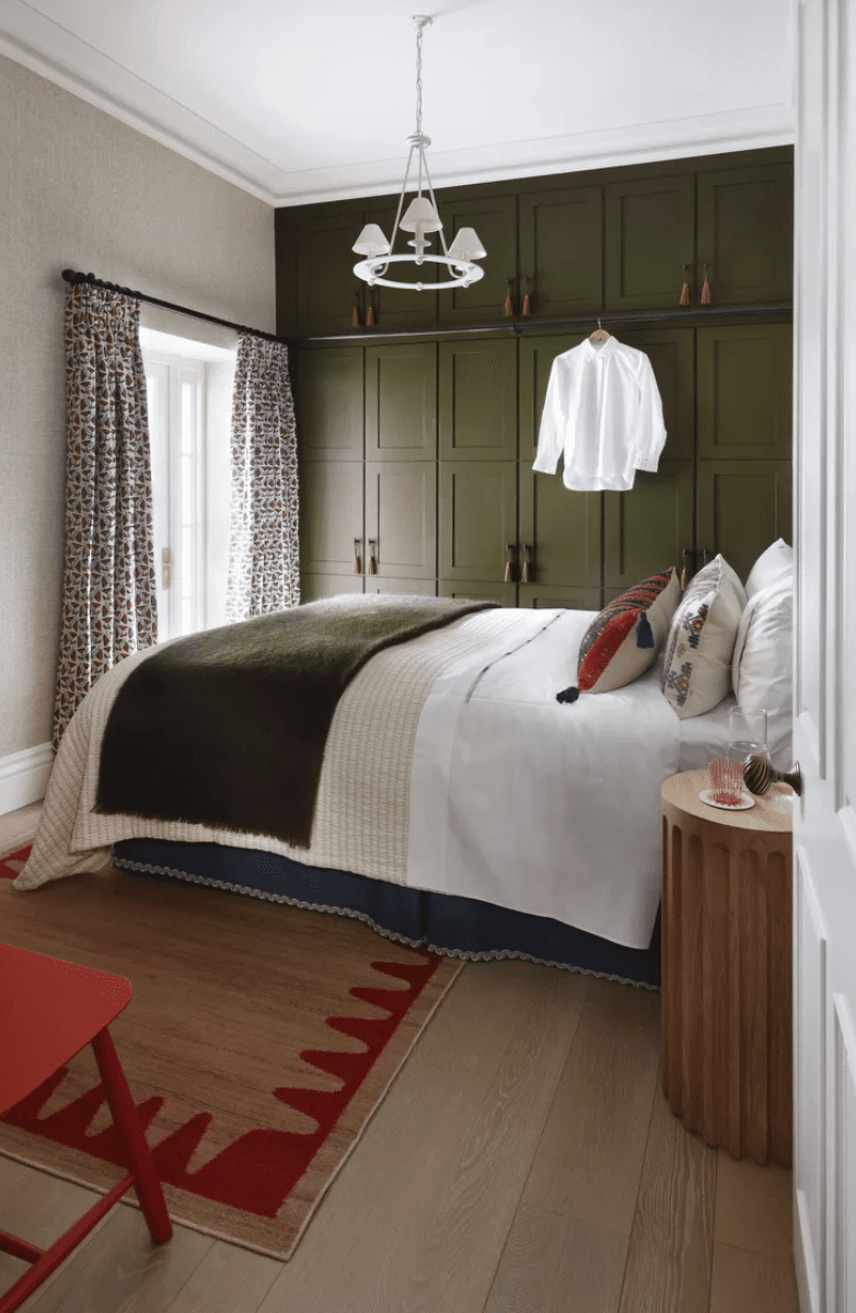 white bedroom with green cabinetry