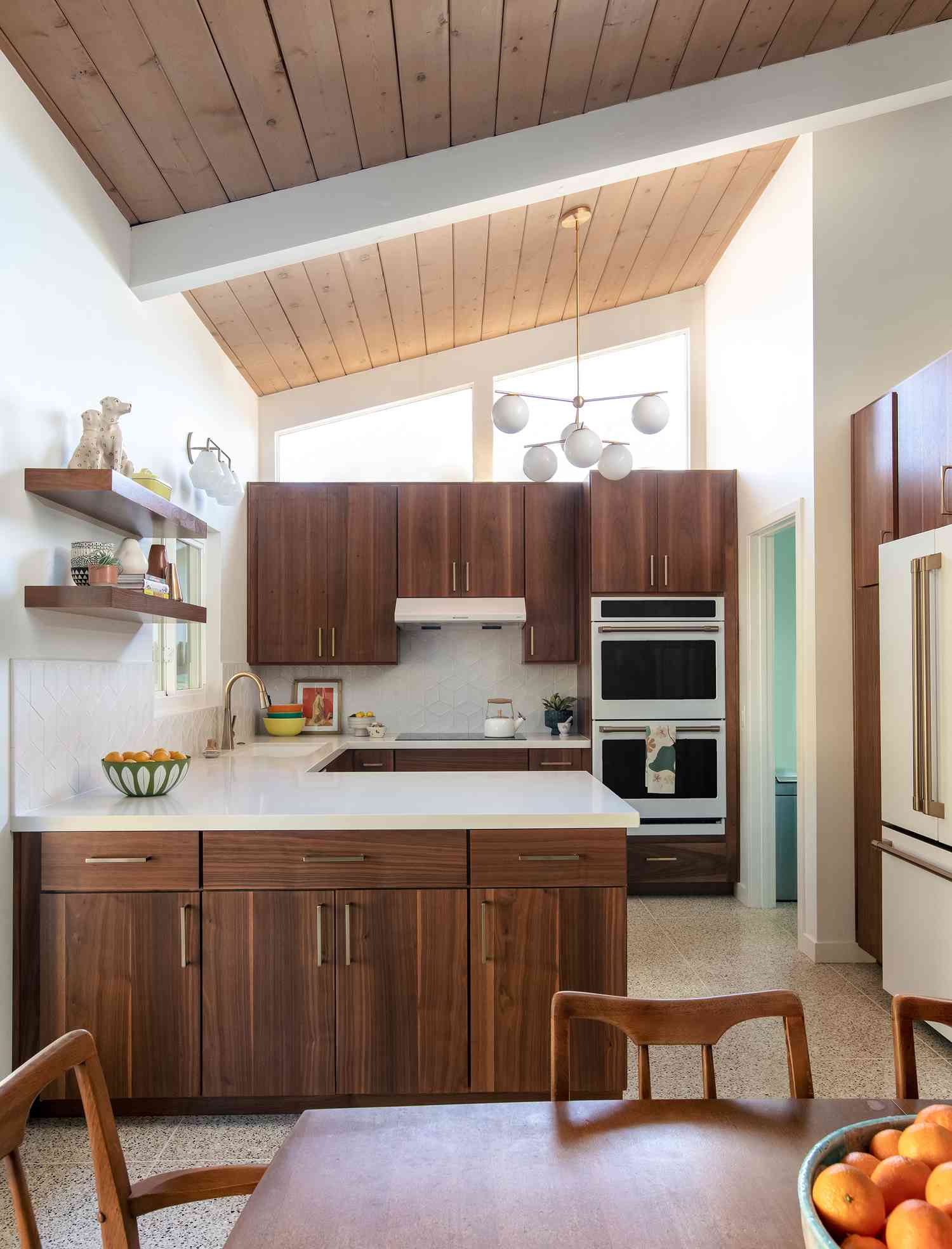 midcentury walnut kitchen with white and gold