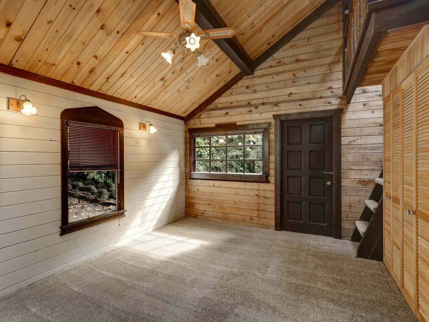 Hallway interior in wooden cabin has unvarnished wood shiplap on the ceiling