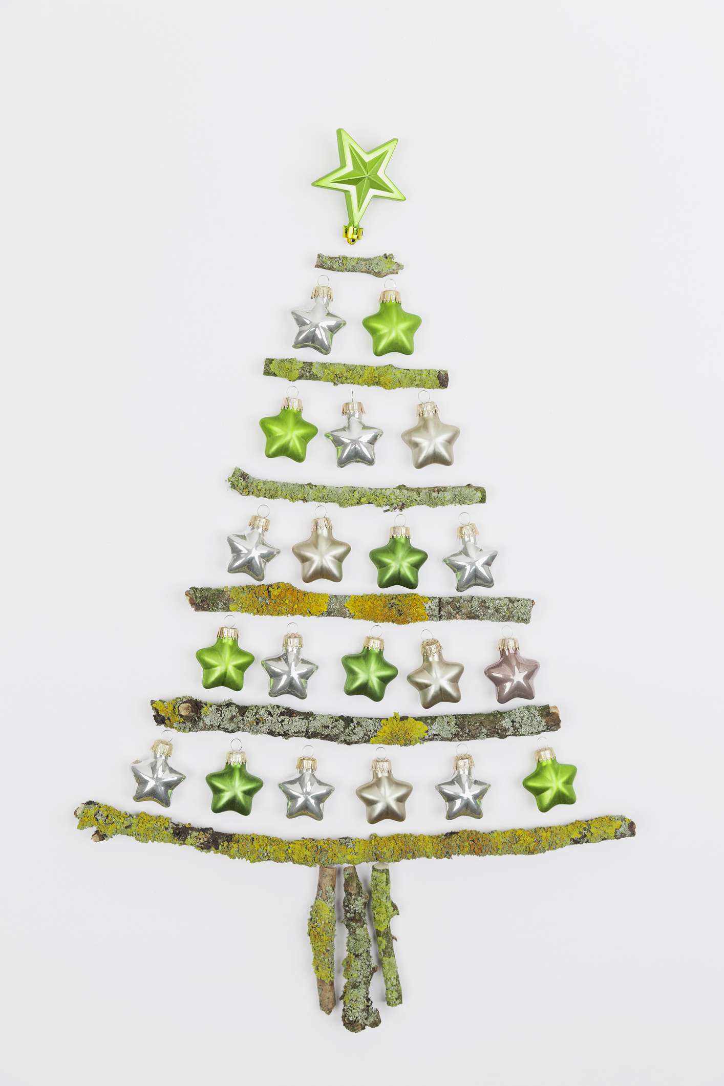 Moosige Zweige und Ornamente in Form eines Weihnachtsbaums