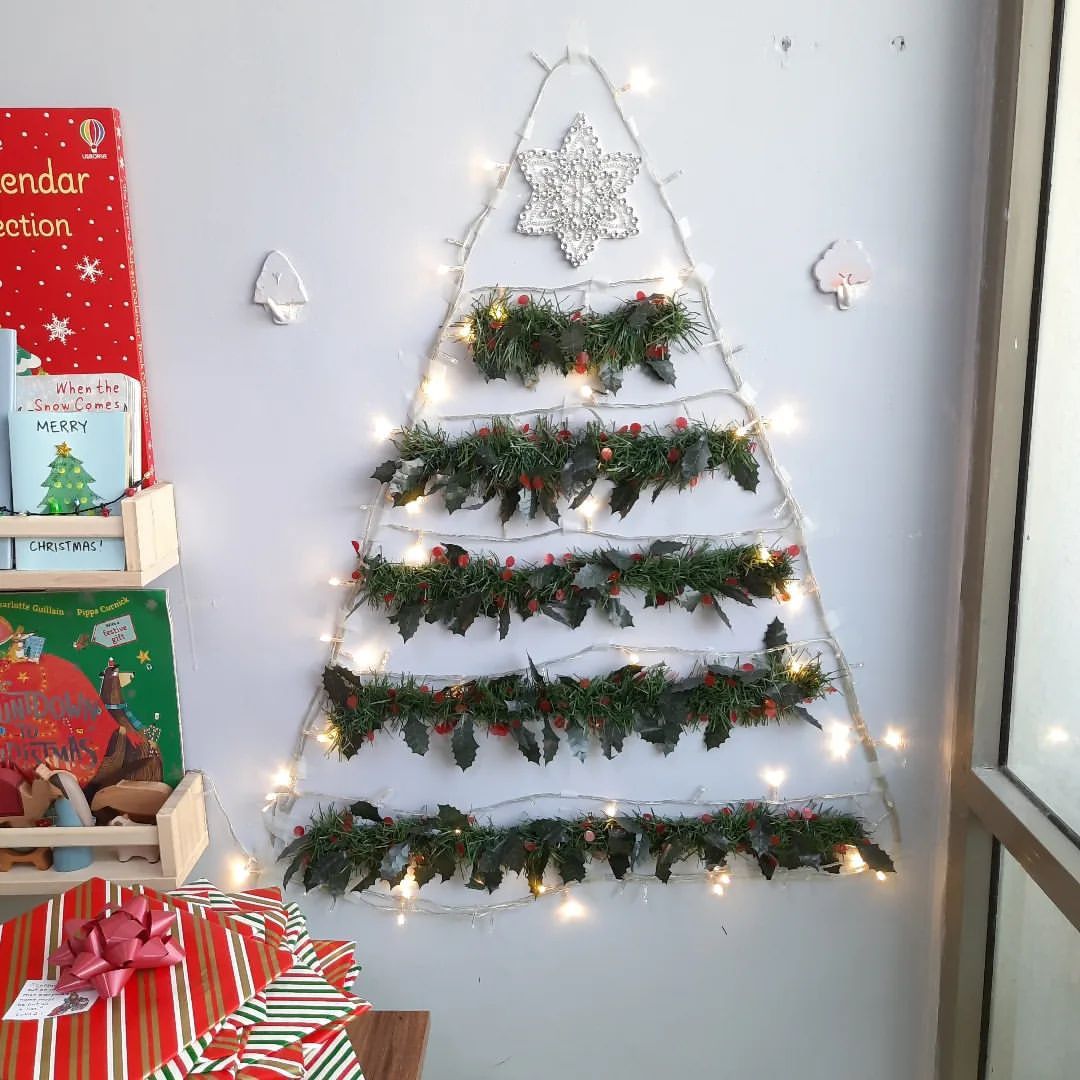 Un árbol de Navidad DIY hecho con ramas de imitación y luces de cuerda