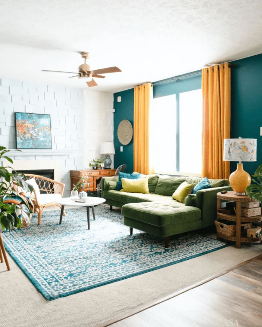 Sala de estar azul-petróleo com cortinas amarelas e sofá seccional moderno de veludo verde de meados do século