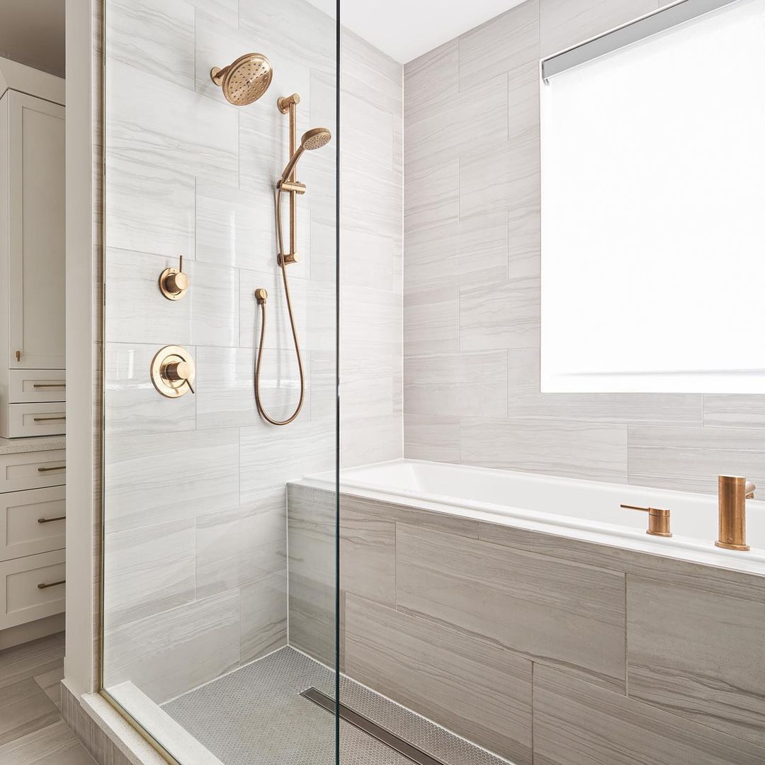 tub inside gray shower brass accents