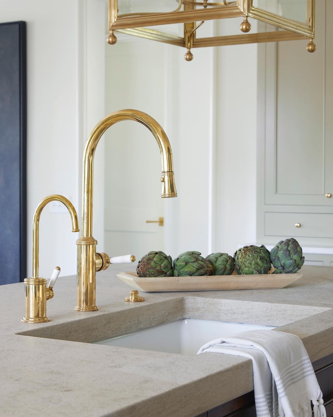 close-up of a sink and limestone countertop