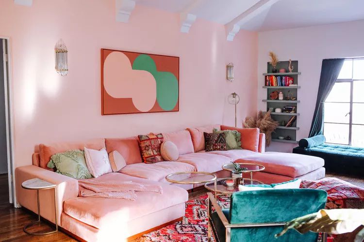 Colorful mid-century modern living room in pink and teal.