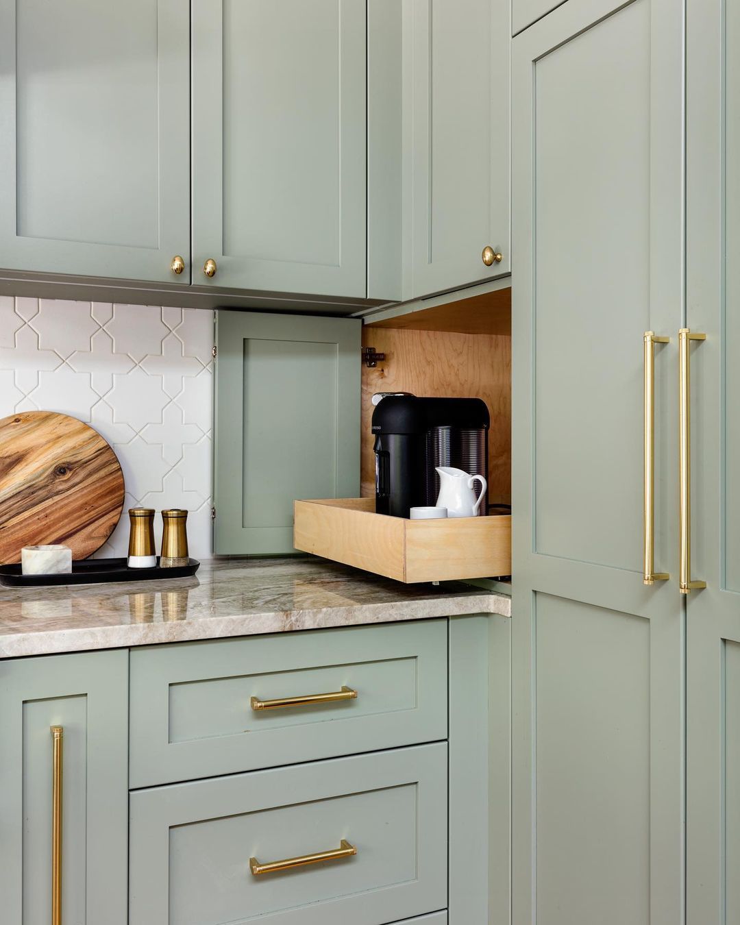 Sage green kitchen cabinets with appliance garage popping out