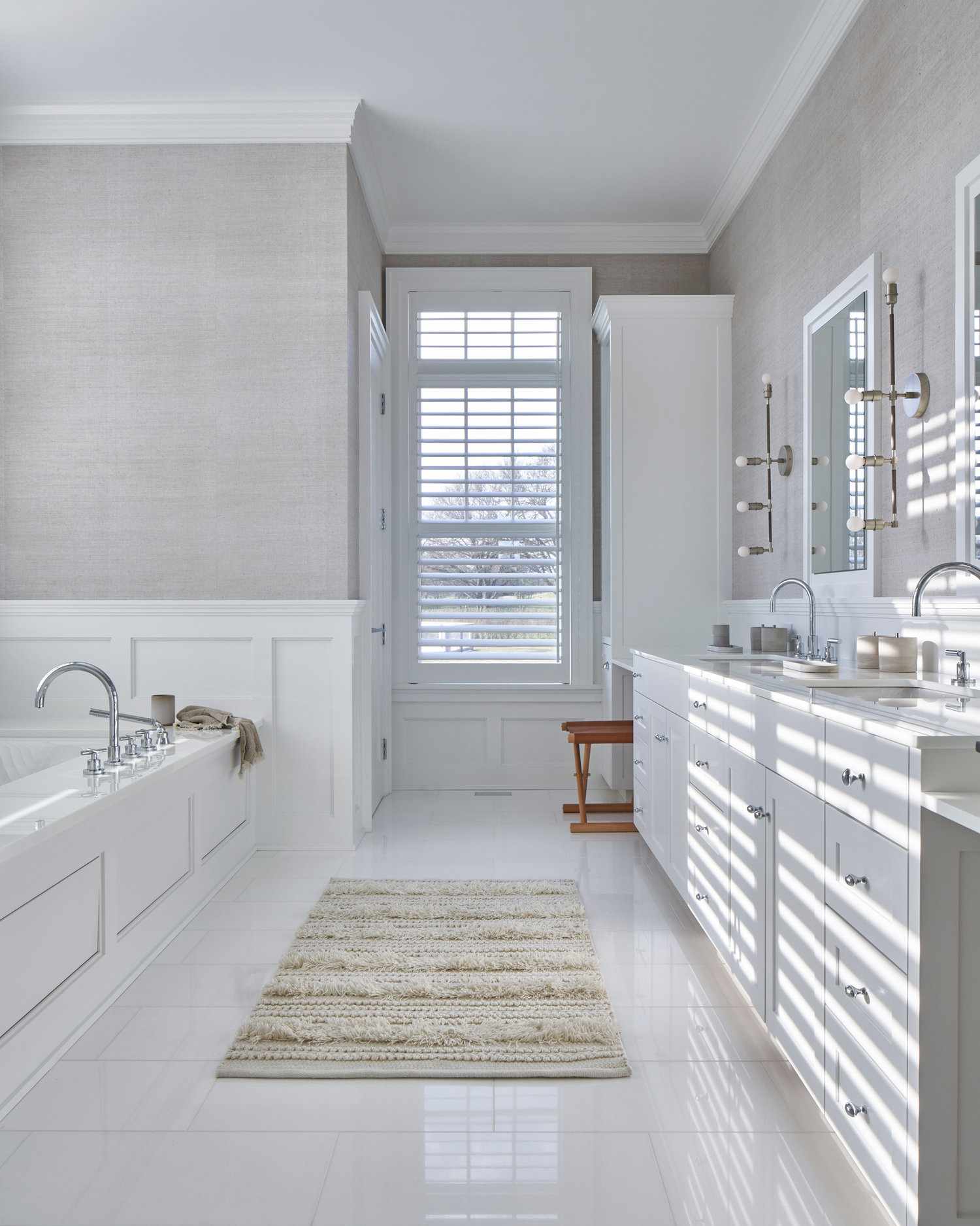 white bathroom wainscoting around built-in tub