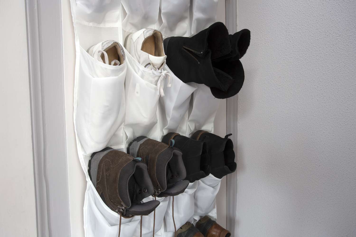 Shoes stored in an over the door rack