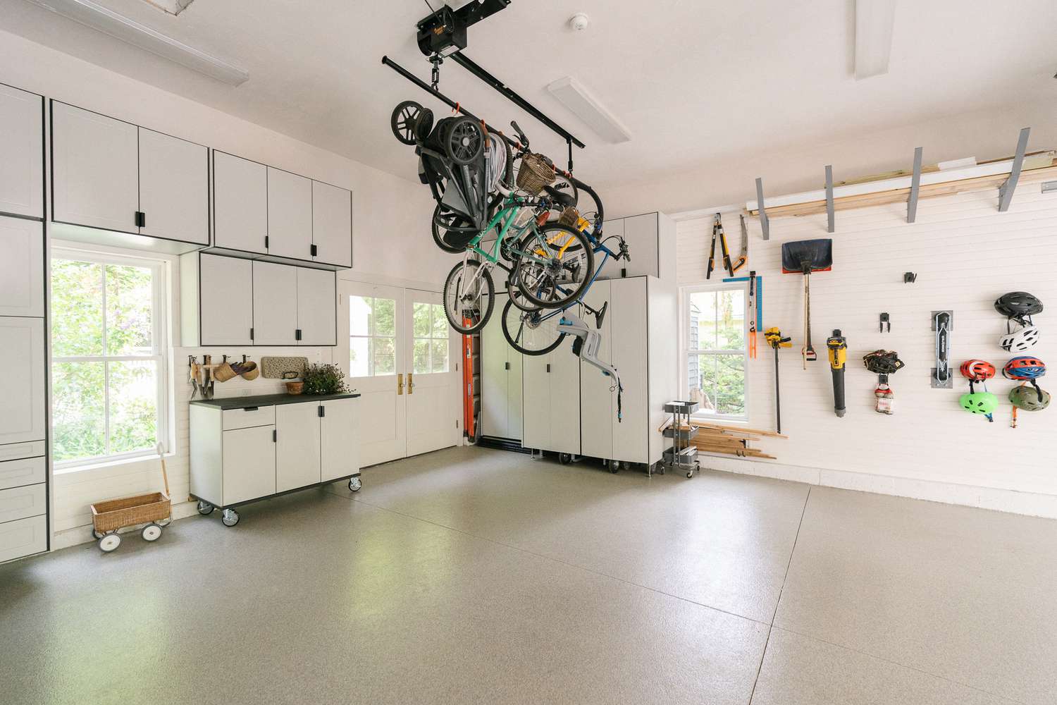 Bikes hanging from a ceiling rack in a garage