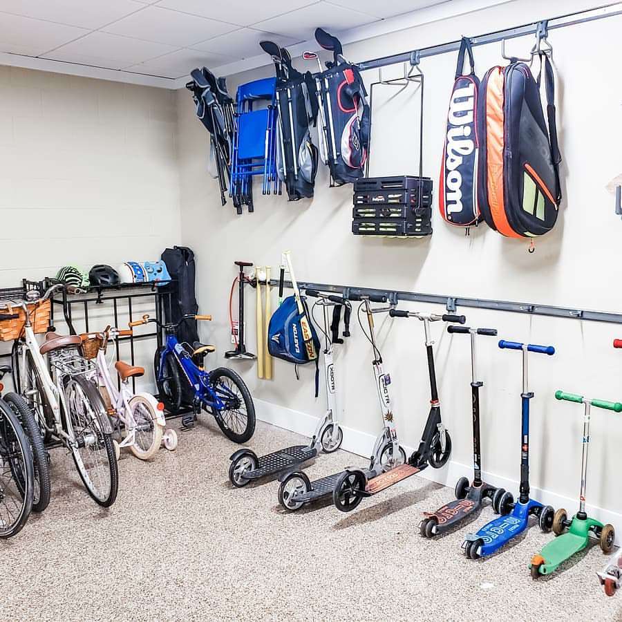 Wall hooks on racks holding scooters and bikes
