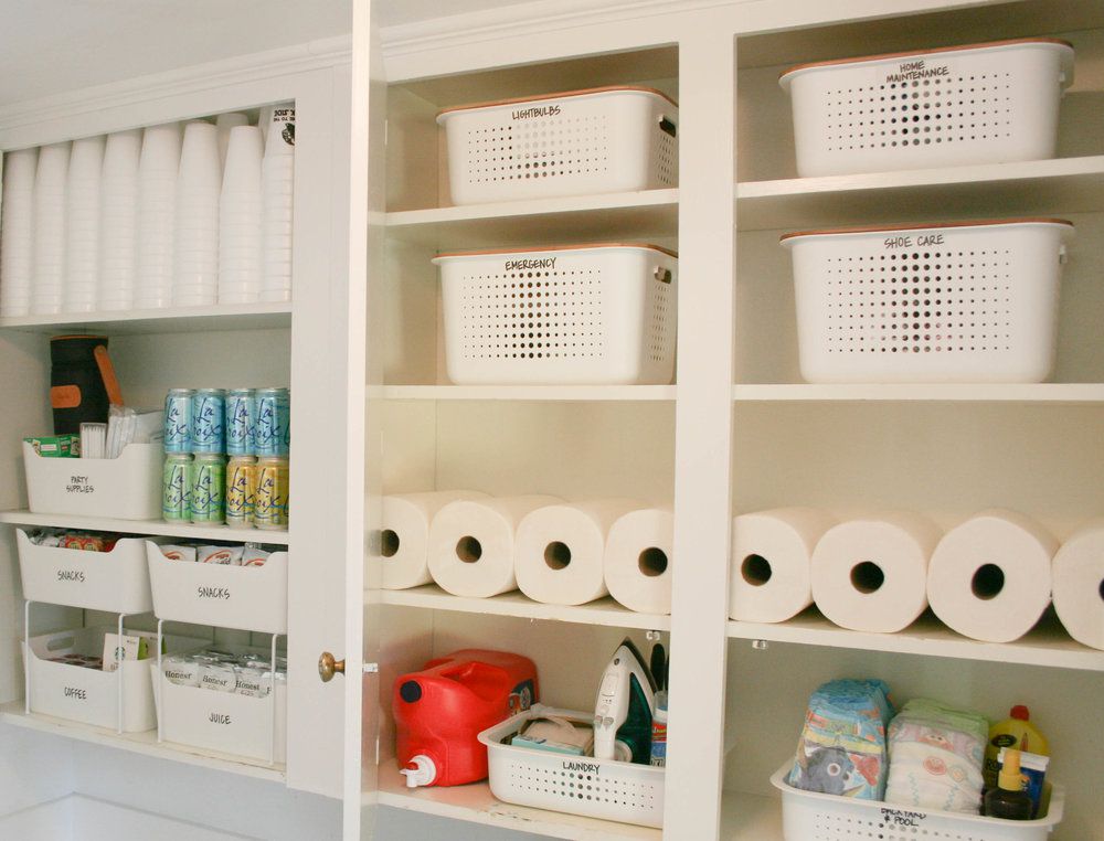 Paper towels and other items stored inside bins in cabinets