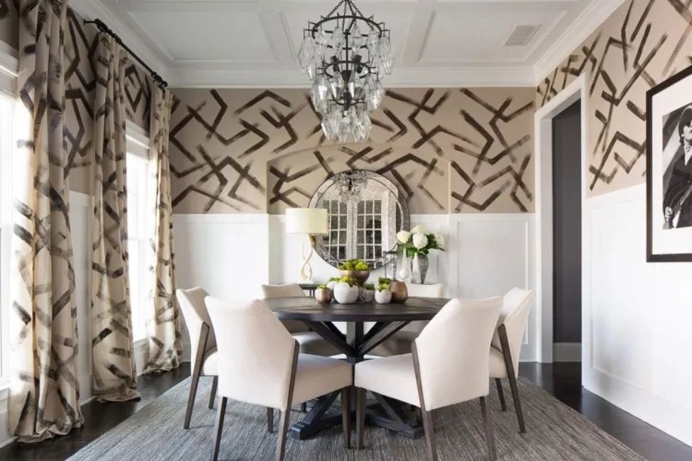 chair rail in dining room with white wainscoting and patterned wallpaper