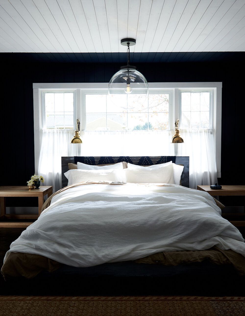 black accent wall white window trim bedroom