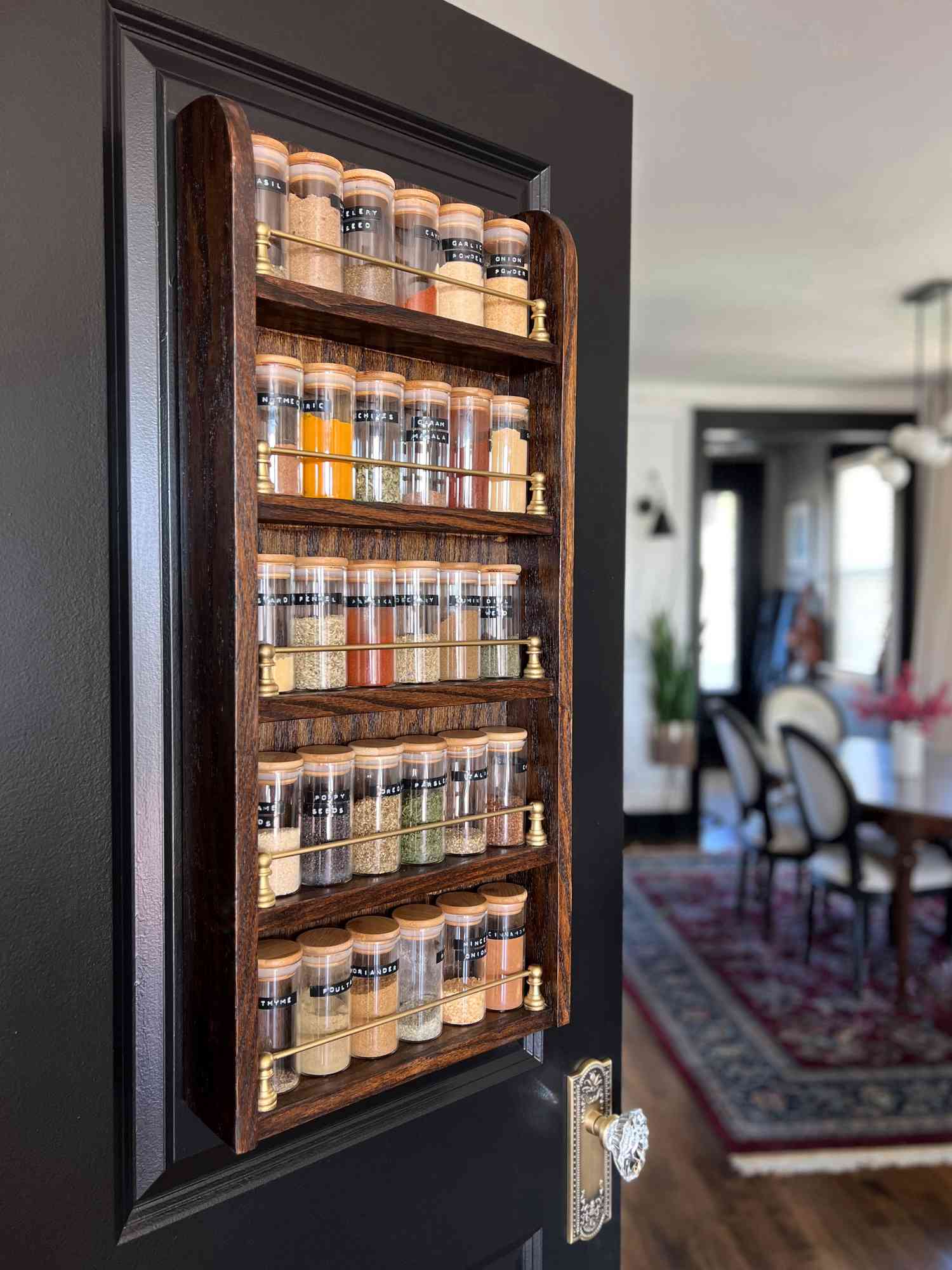 A DIY spice rack hung on a pantry door