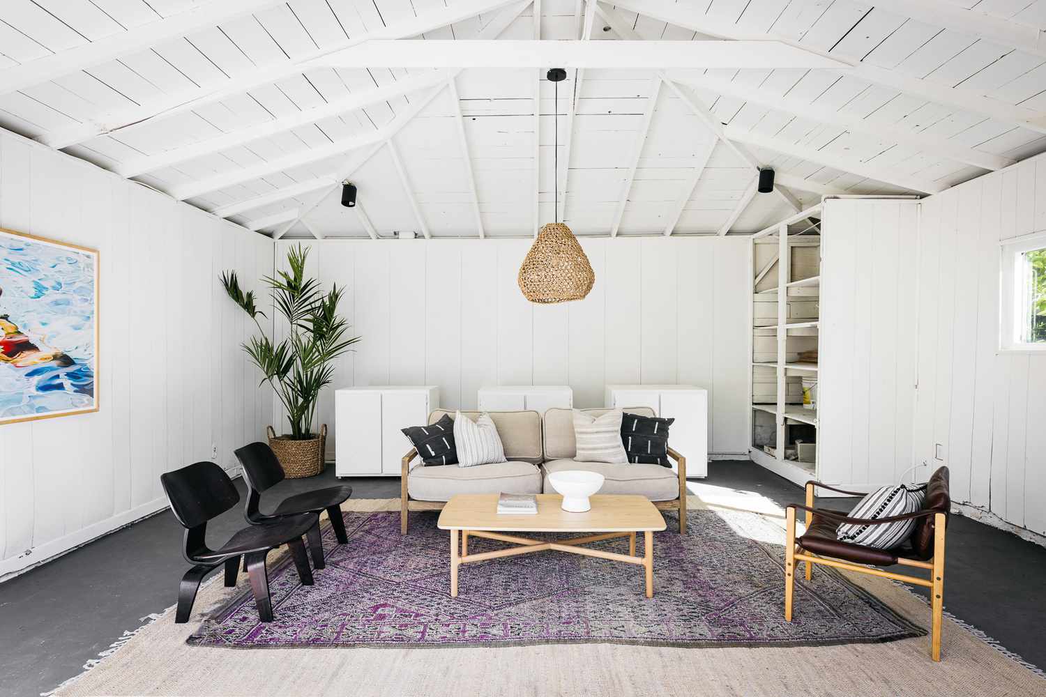 Interior of she-shed with seating on top of purple patterned area rug