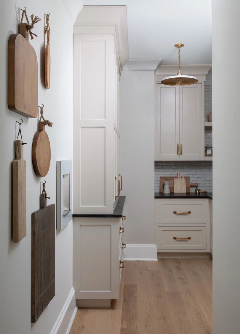 Walk-In Pantry with Cutting Boards Hung on Wall 