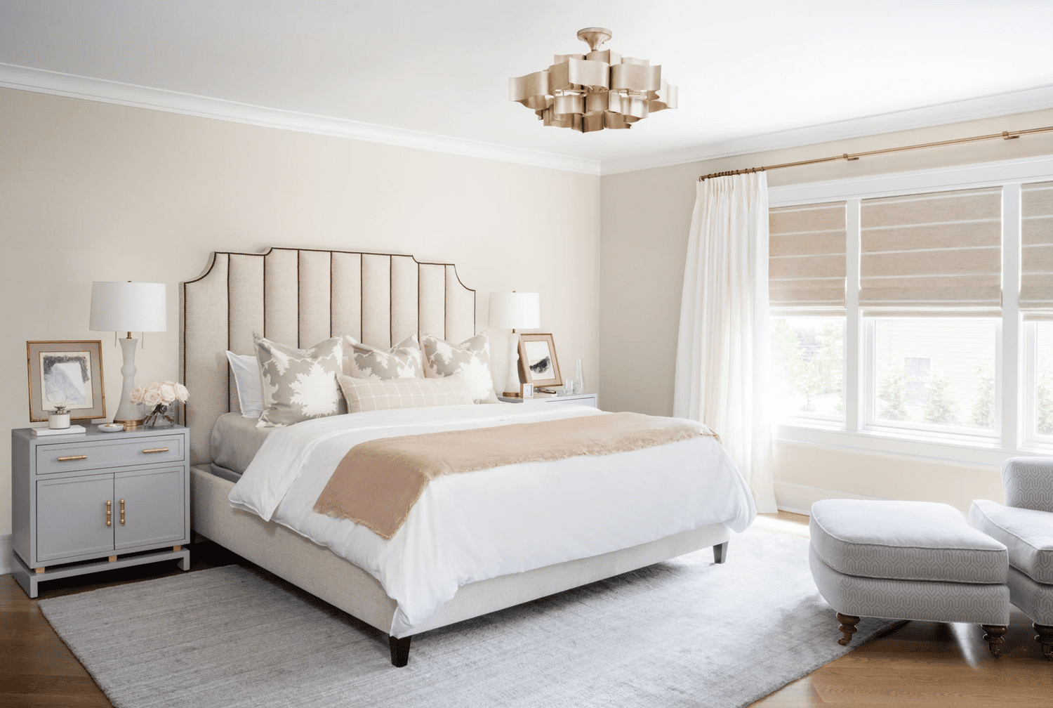 dormitorio crema con silla gris y otomana