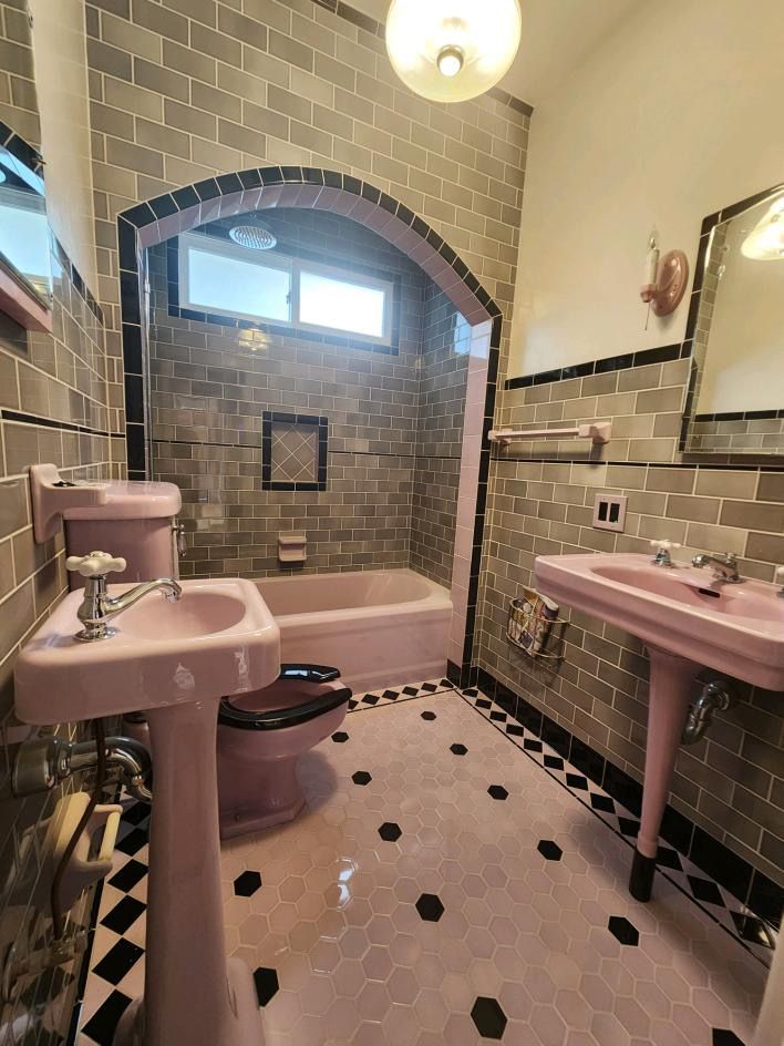 Banheiro em estilo vintage com acessórios de encanamento roxos.