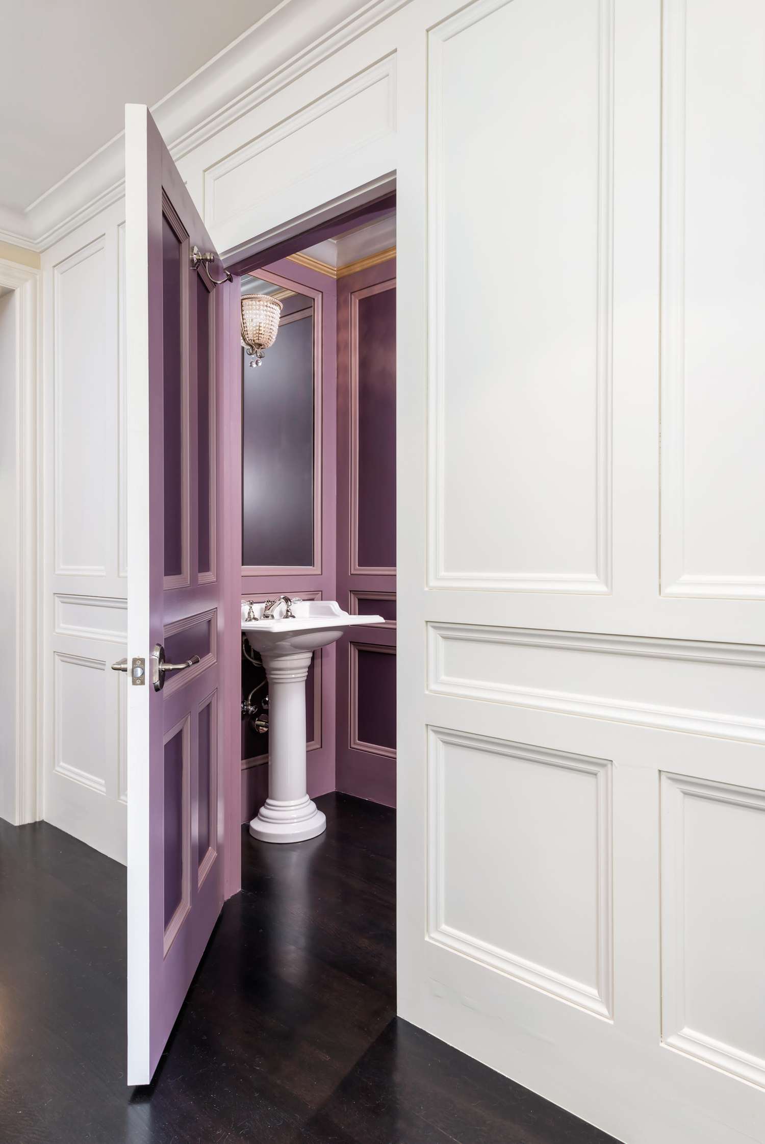 Purple bathroom with two-toned wall paneling.