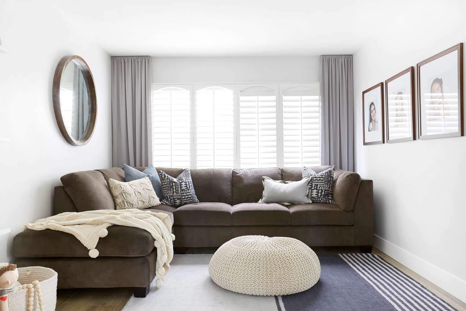 brown sectional and gray curtains