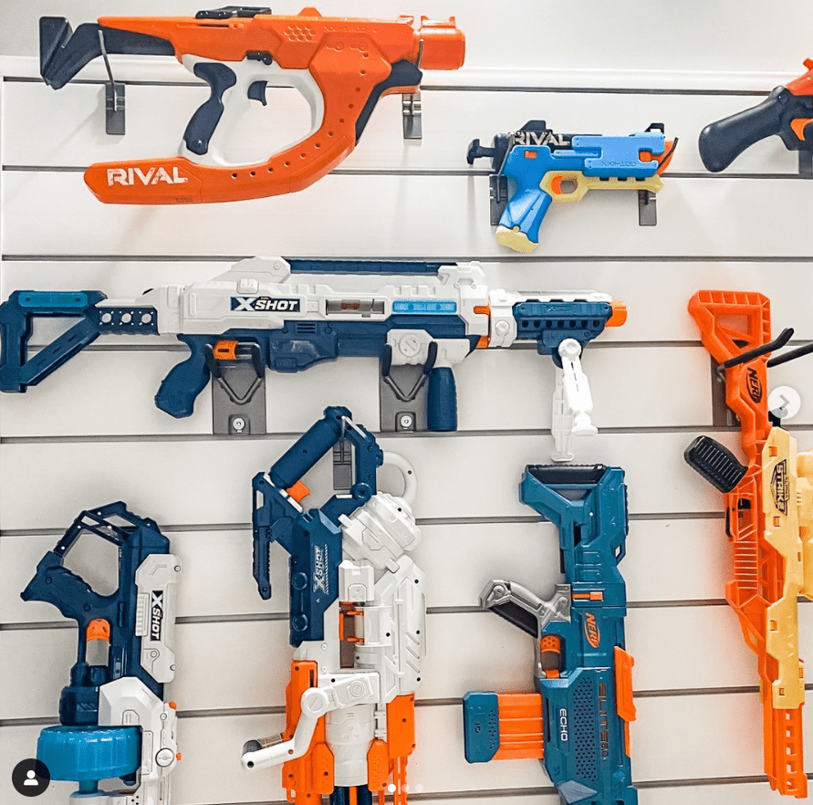A garage shiplap wall of nerf guns