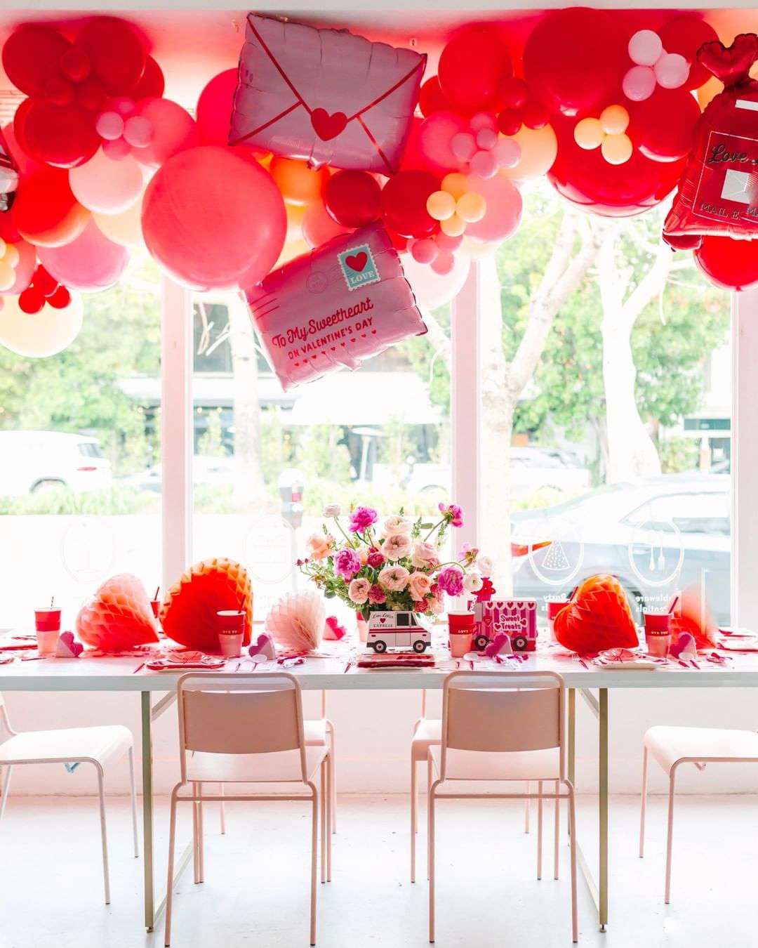 Pink and red balloons above Valentine's Day table