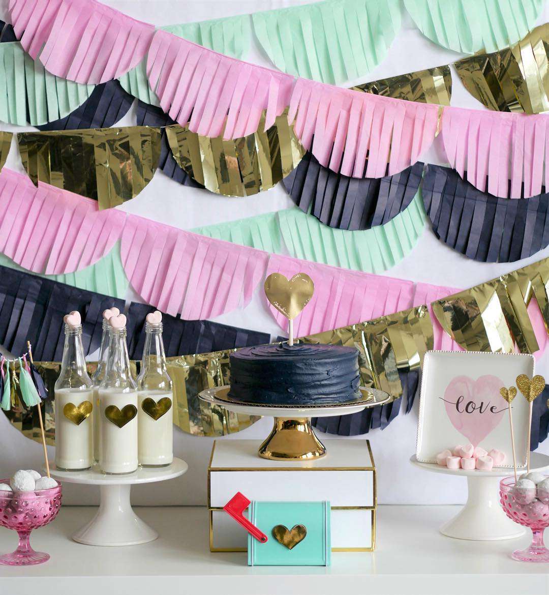 Mint, pink, gold, and navy banners over table
