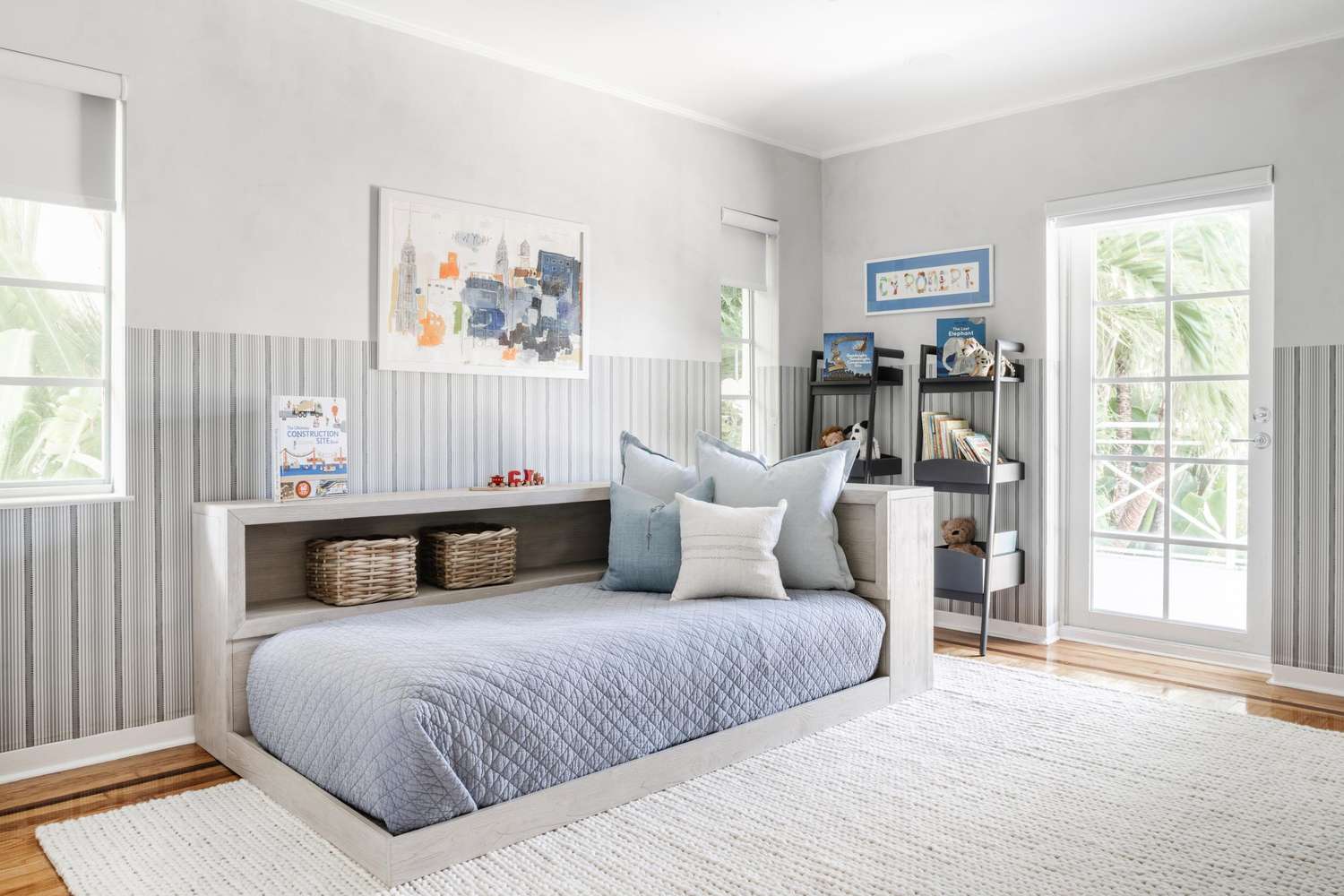 Kids' bedroom with light blue bedding and accents and light gray walls
