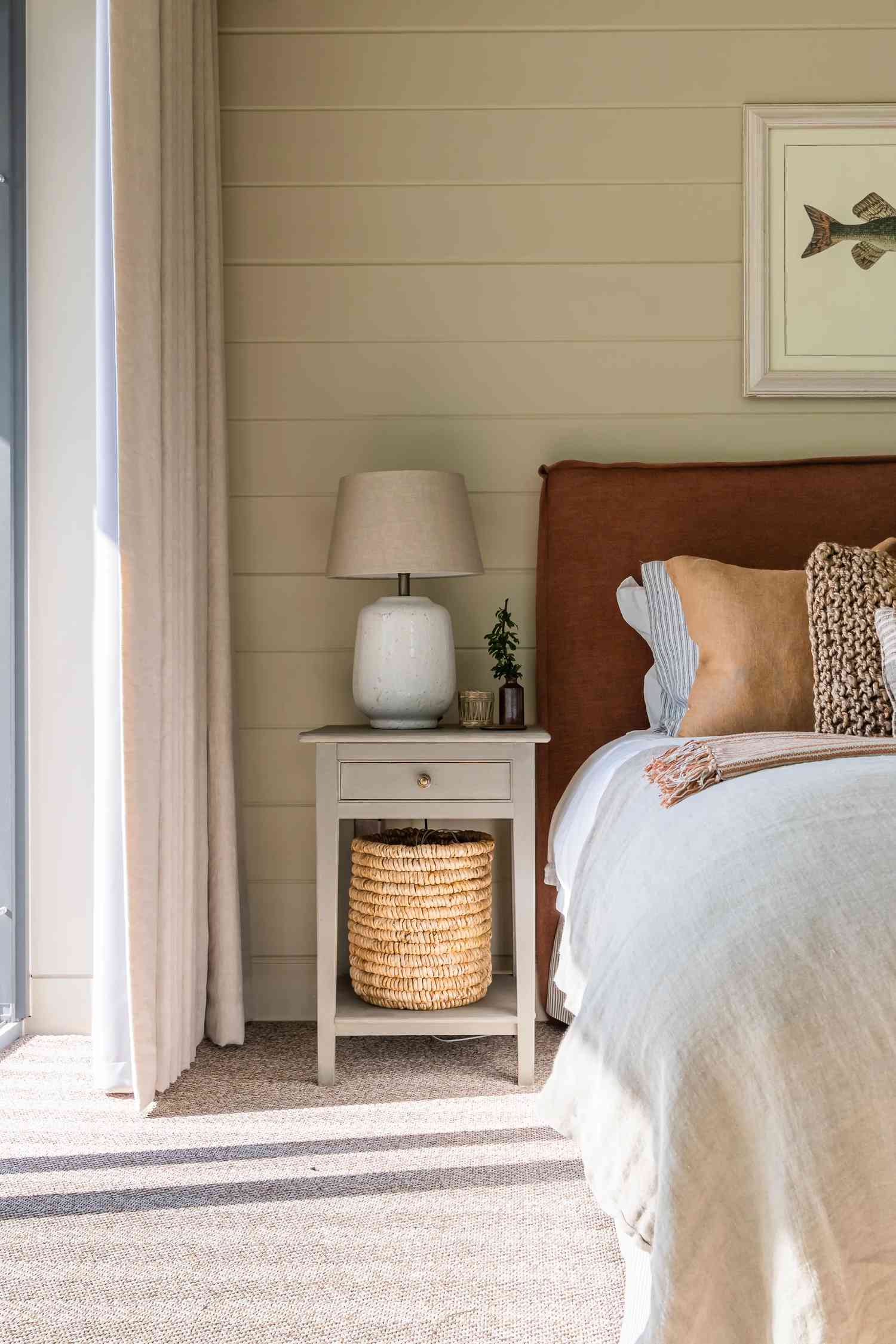 Wide horizontal shiplap painted in a light beige color behind a headboard
